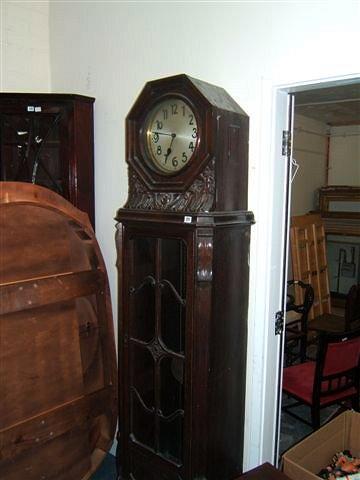 Appraisal: An Art Deco oak long case clock with carved case