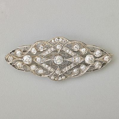 Appraisal: DIAMOND AND PLATINUM FILIGREE BROOCH Delicate pierced platinum filigree setting