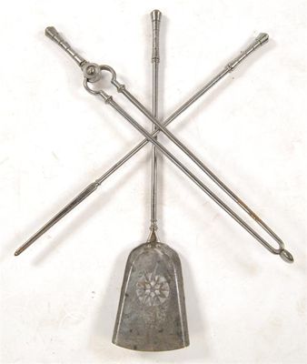 Appraisal: A set of polished steel fire irons having waisted knopped