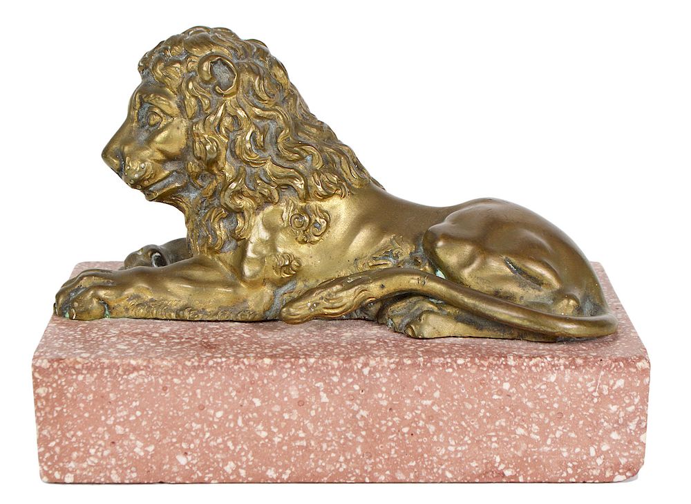 Appraisal: th Ct Bronze Lion on Porphyry Base Reclining bronze figure