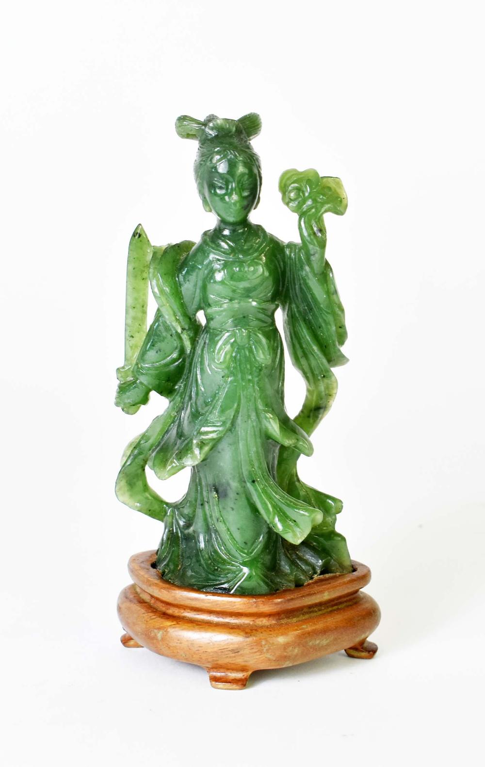 Appraisal: CHINESE SPINACH JADE QUANYINDressed in elaborate robes holding a sword