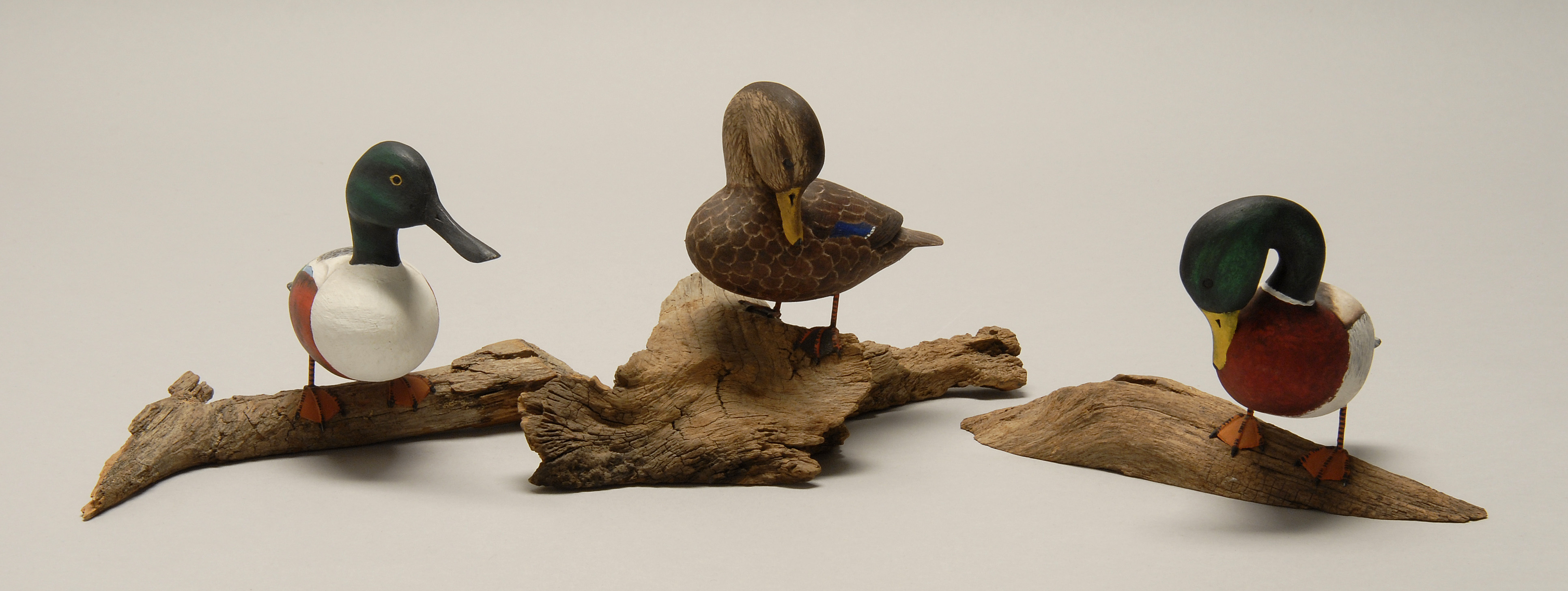 Appraisal: THREE MINIATURE BIRD CARVINGS A mallard a black duck and