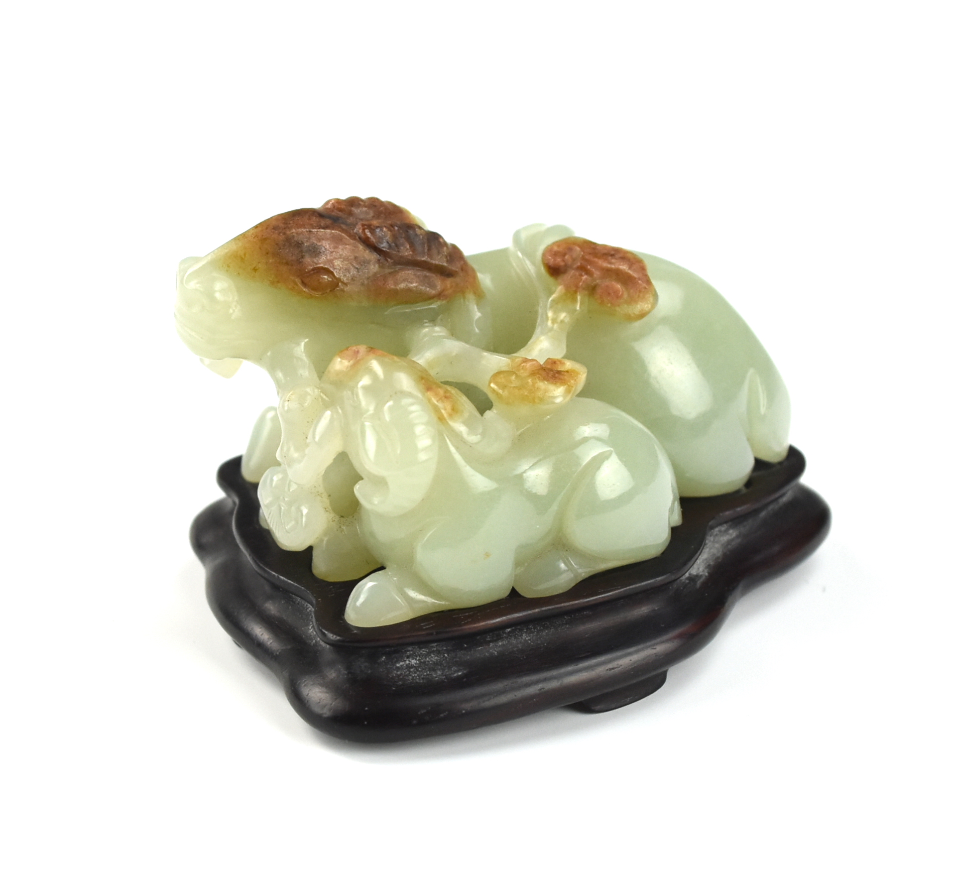 Appraisal: CHINESE JADEITE GOATS W WOOD STAND the goats carved recumbent