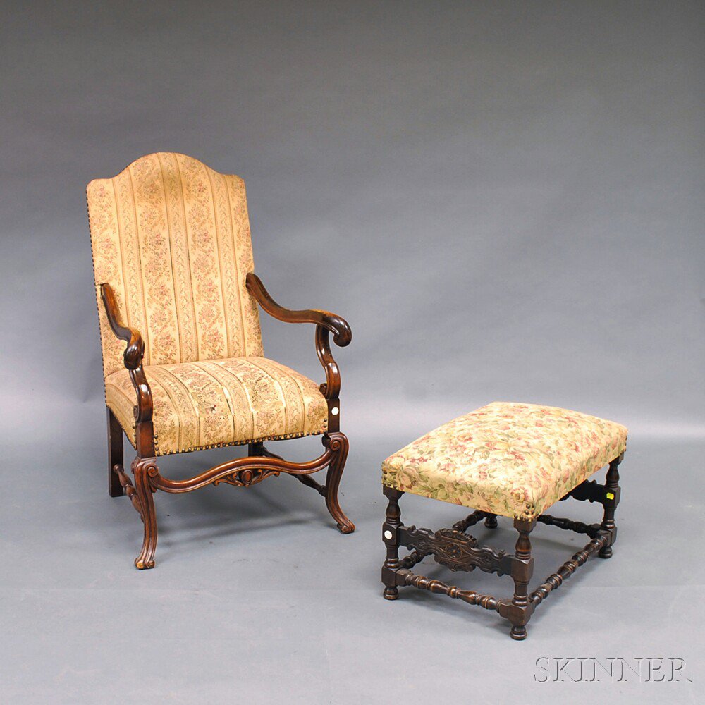 Appraisal: Jacobean-style Mahogany Carved and Upholstered Armchair and Ottoman chair with