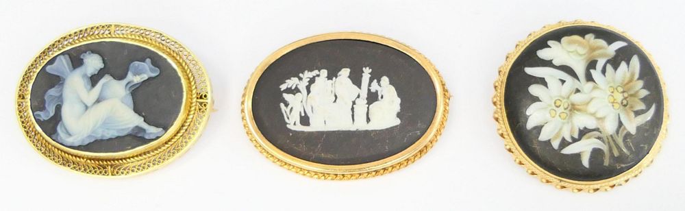 Appraisal: COLLECTION OF CAMEO STYLE BLACK WHITE PINS One is MOP