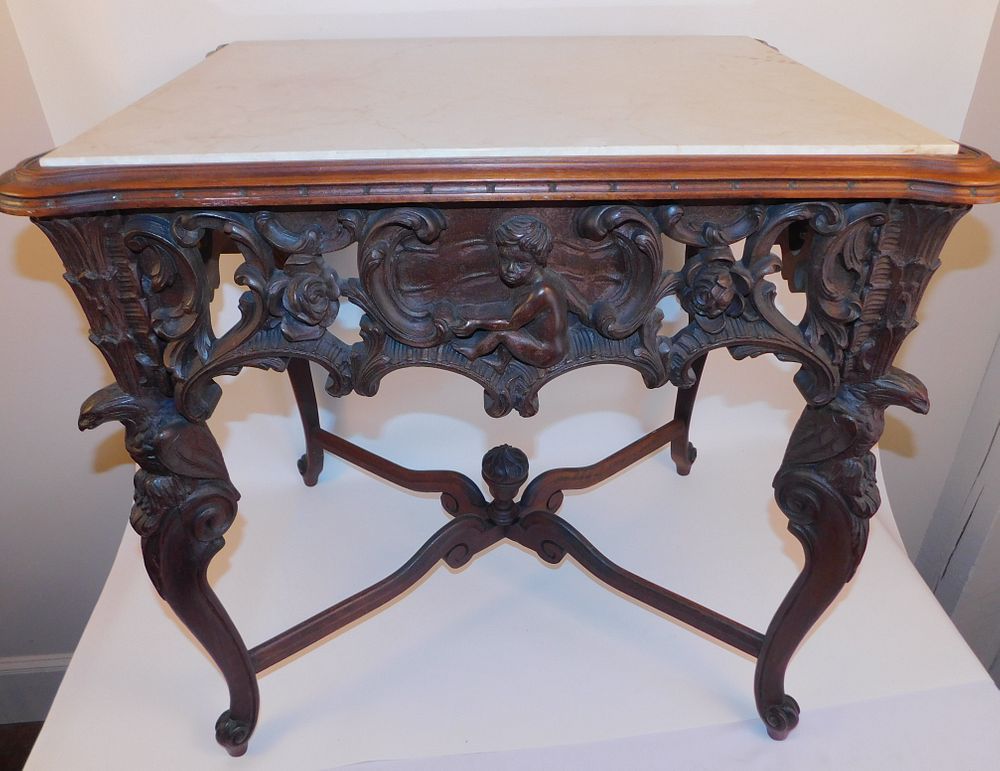 Appraisal: ANTIQUE CHERUB CARVED MARBLE TOP TABLE Antique walnut marble top