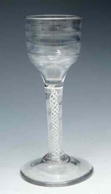 Appraisal: A LYNN WINE GLASS with horizontally ribbed round funnel bowl