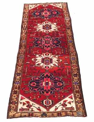 Appraisal: A Heriz Palace Runner Red variegated ground with blue and