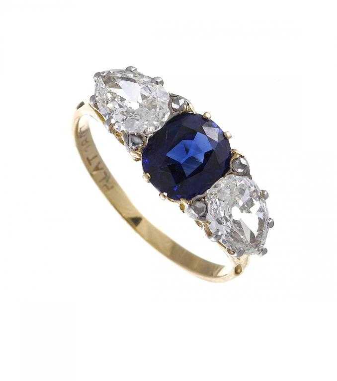 Appraisal: A SAPPHIRE AND DIAMOND RING the oblong sapphire flanked by