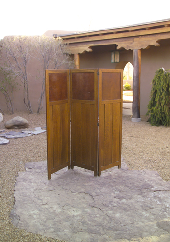 Appraisal: GUSTAV STICKLEY Three-panel screen with paneled base and brown leather-paned