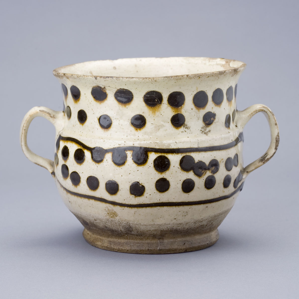 Appraisal: ENGLISH SLIPWARE POSSET POT LATE SEVENTEENTH-EARLY EIGHTEENTH CENTURY Of spherical