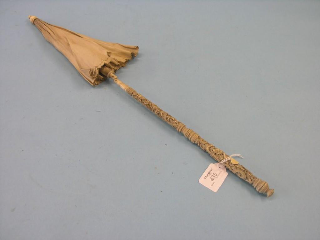 Appraisal: A th century Canton ivory parasol handle carved in fine