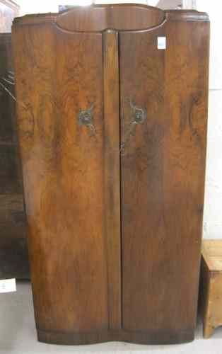 Appraisal: BURL WALNUT TWO-DOOR WARDROBE English mid- th century the interior