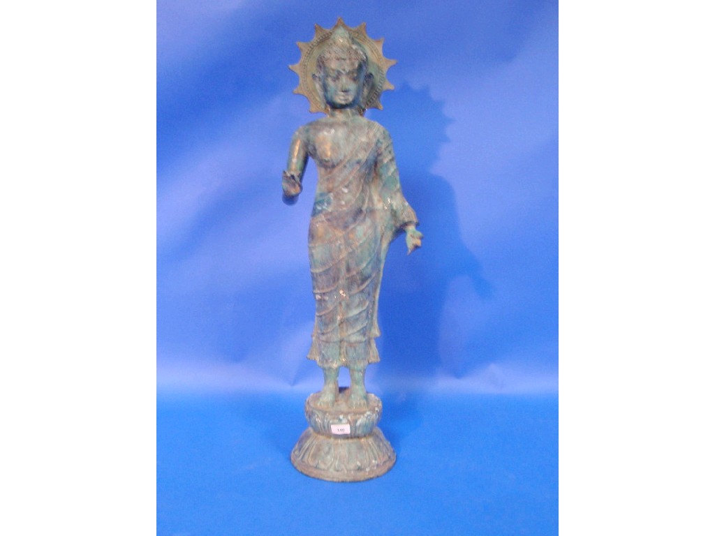 Appraisal: A cast patinated standing figure of a Buddha with pendulous