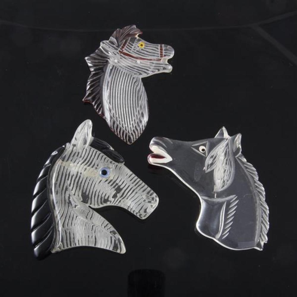 Appraisal: THREE CARVED AND REVERSE CARVED LUCITE HORSE PINS WITH PAINTED