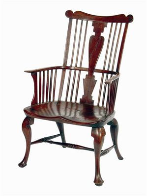 Appraisal: A mid th century cherrywood comb-back Windsor armchair attributed to