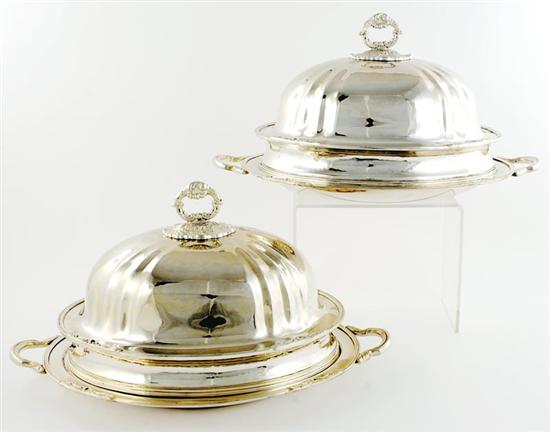 Appraisal: Pair silverplate platters with domes foliate capped finial-form handle on