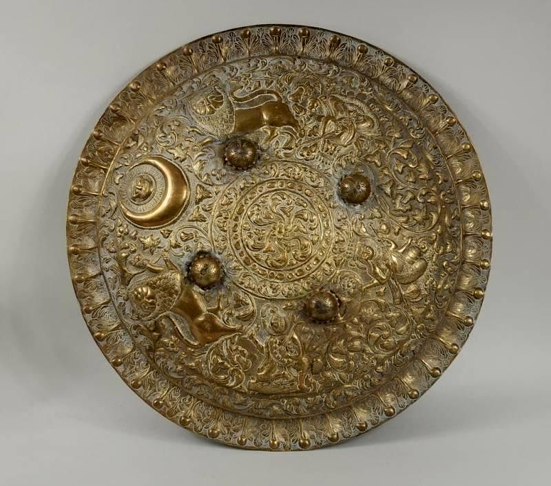 Appraisal: Indian Repousse Brass Shield Indian repousse brass shield depicting lions