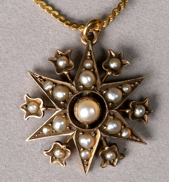 Appraisal: A PEARL SET PENDANT in the form of a star