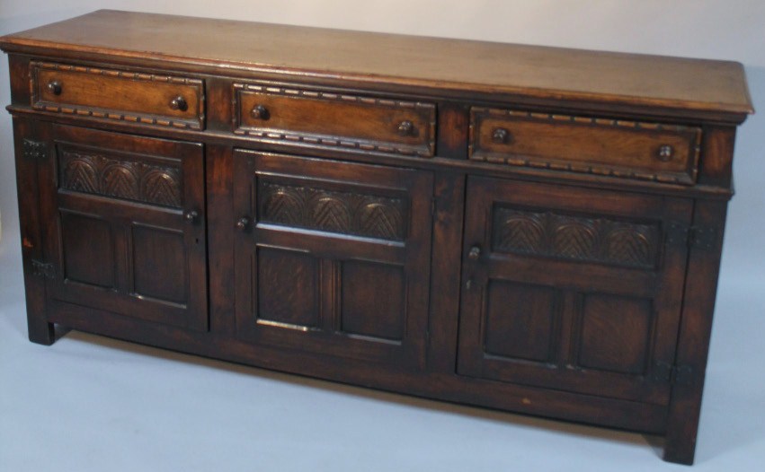 Appraisal: A thC Old Charm style sideboard the rectangular moulded top