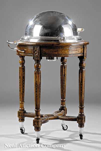 Appraisal: A Silverplate and Oak Serving Trolley the revolving domed lid