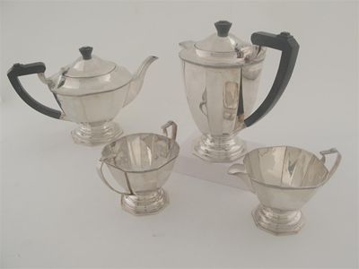 Appraisal: A modern four piece tea set of panelled vase form