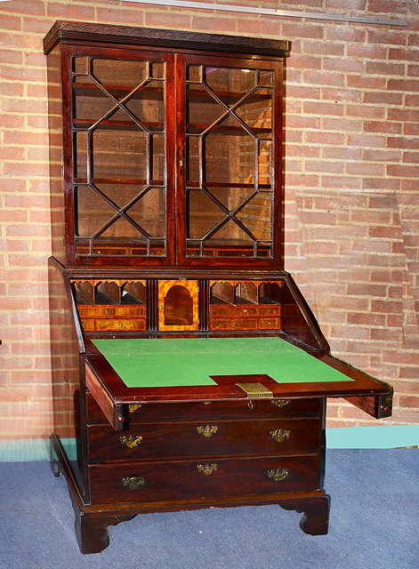 Appraisal: A GEORGE III MAHOGANY BUREAU with bookcase over fitted interior