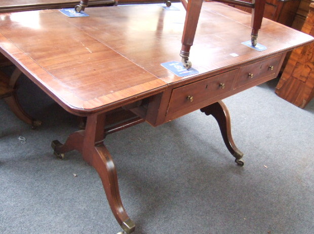 Appraisal: A Regency mahogany sofa table the satinwood crossbanded drop flap