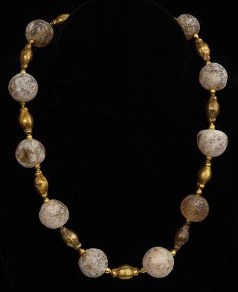 Appraisal: PERSIAN GLASS AND HOLLOW-GOLD BEAD NECKLACE in Provenance Property from