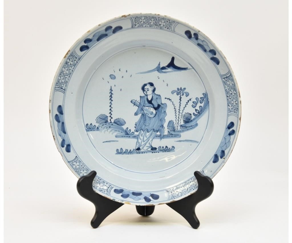 Appraisal: Dutch delft deep charger th c with Asian landscape dia