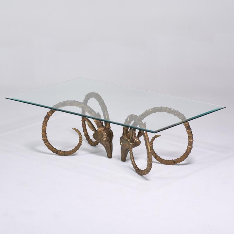 Appraisal: ALAIN CHERVET Attr Coffee table s Brass ibex heads glass