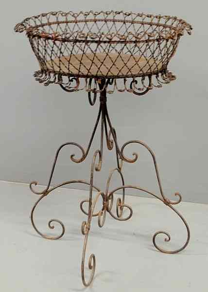 Appraisal: Large wire planter th c with oval basket and scrolled