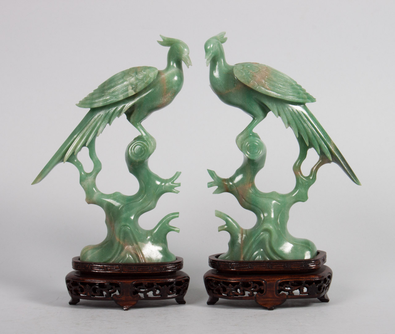 Appraisal: Pair of Chinese carved jade phoenixes modeled as bird perched