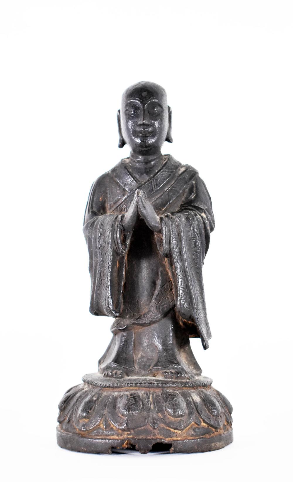 Appraisal: CHINESE BRONZE FIGURE OF A PRIESTMing Qing Dynasty The figure