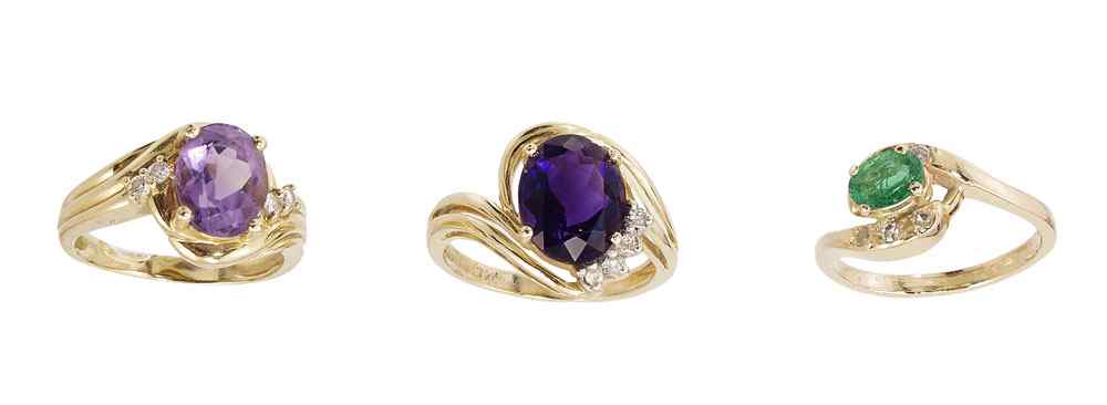 Appraisal: THREE K GEMSTONE RINGS K rings with amethyst emerald and