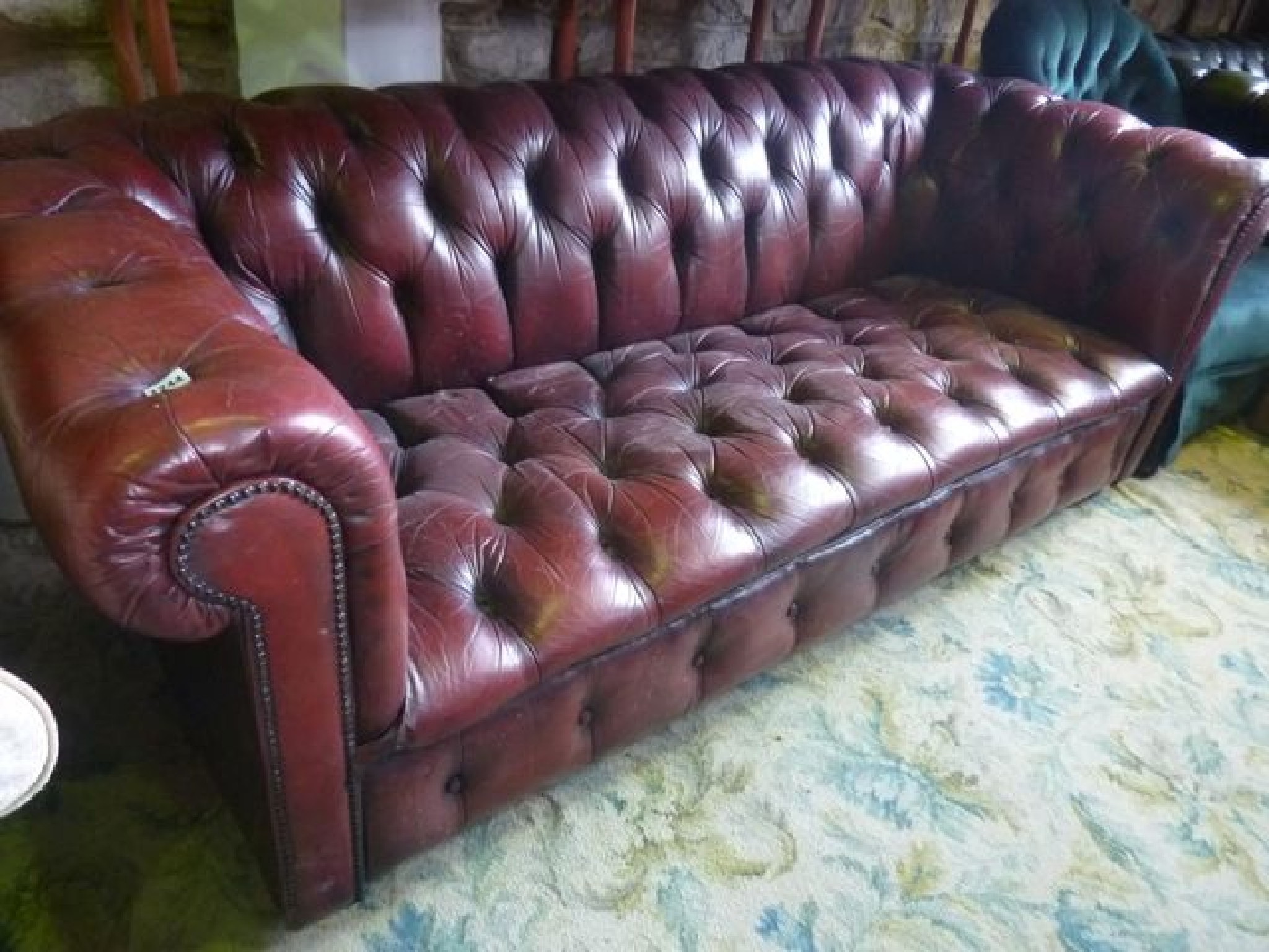 Appraisal: A contemporary -seat Chesterfield type sofa with ox blood leather