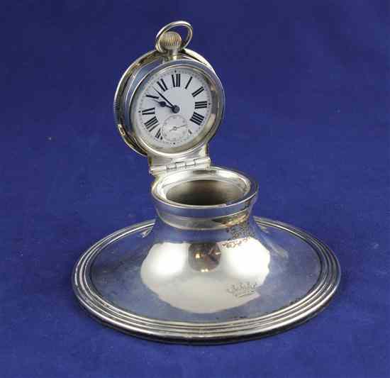 Appraisal: An Edwardian silver capstan inkwell watch holder by William Comyns