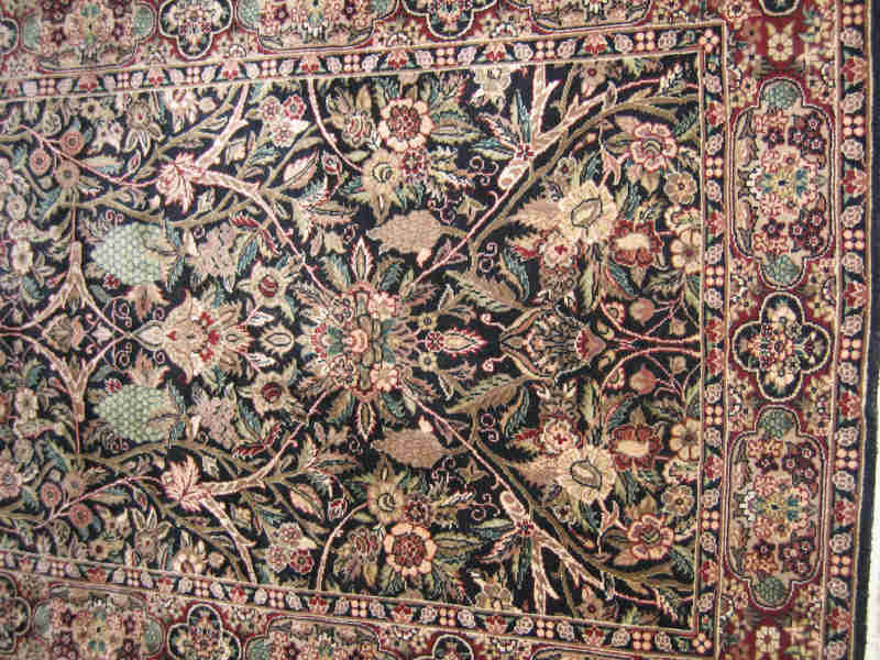 Appraisal: SINO PERSIAN THROW RUG The indigo field of floral design