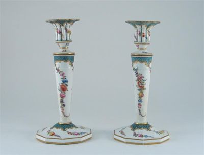 Appraisal: A pair of Dresden candlesticks painted with flowers within green