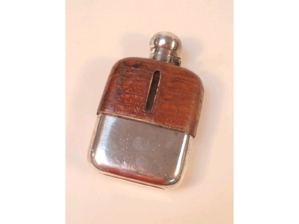 Appraisal: An Edwardian leather and silver covered hipflask Sheffield maker J