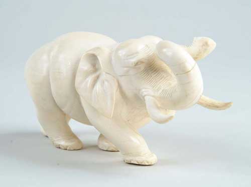 Appraisal: CARVED IVORY ELEPHANT Nicely formed with curving trunk and tusks