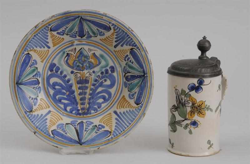 Appraisal: CONTINENTAL TIN-GLAZED EARTHENWARE LIDDED MUG AND A DISH The one