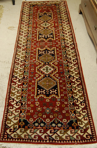 Appraisal: HAND KNOTTED ORIENTAL SHORT RUNNER double geometric medallion and stylized