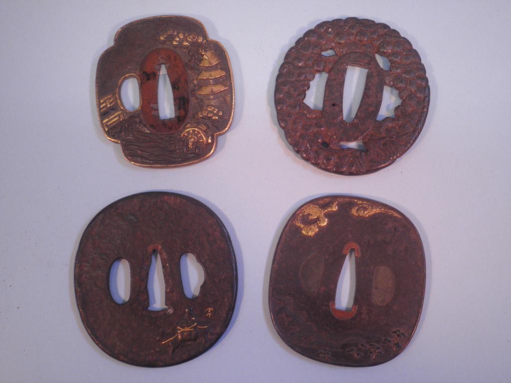 Appraisal: A Japanese bronze tsuba with yellow metal inlay in the