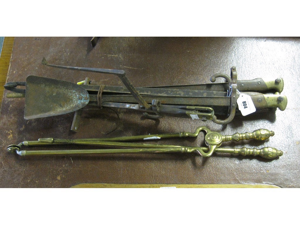 Appraisal: Lot comprising two brass fire irons and a set of