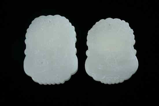 Appraisal: TWO CHINESE CELADON JADE PENDANTS Carved to depict two old