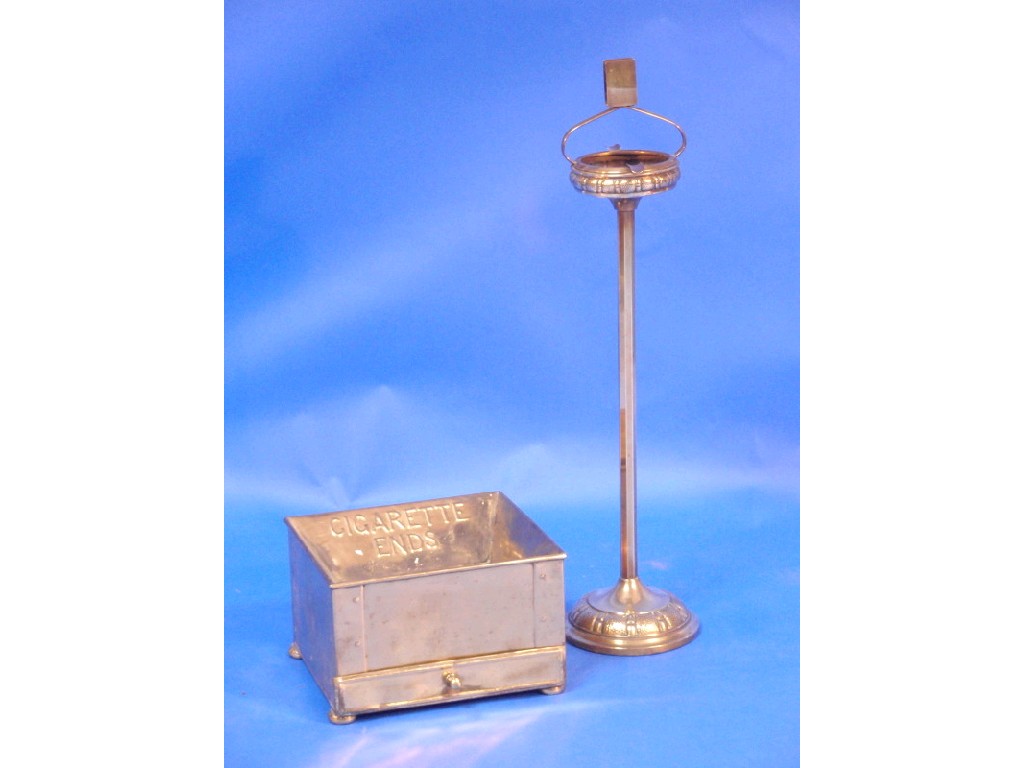 Appraisal: An embossed brass smokers stand and a brass receptacle for