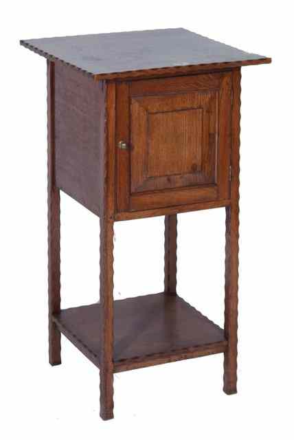 Appraisal: AN OAK BEDSIDE CUPBOARD with single moulded panel door and