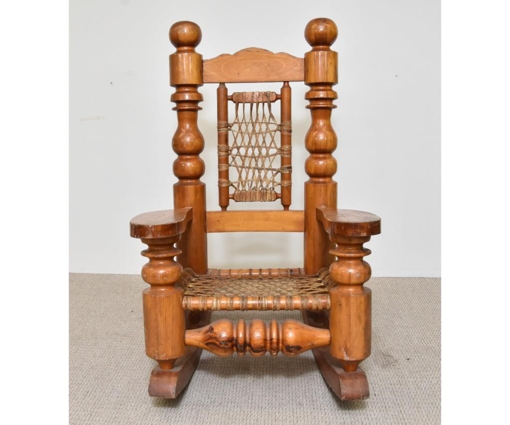 Appraisal: Massive pine Alpine style rocking chair with rawhide back and