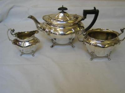 Appraisal: AN EDWARDIAN THREE PIECE TEA SET of moulded oval bombe